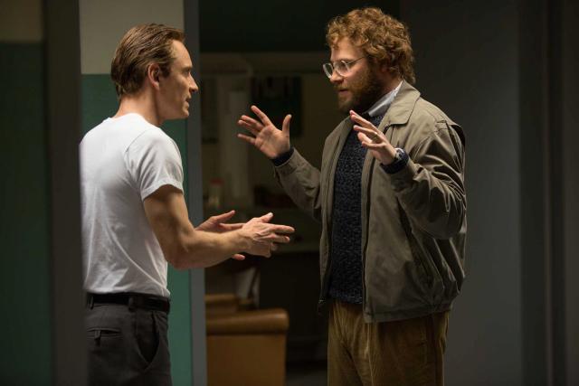 (L to R) Steve Jobs (MICHAEL FASSBENDER) and Steve Wozniak (SETH ROGEN) in “Steve Jobs”, directed by Academy Award® winner Danny Boyle and written by Academy Award® winner Aaron Sorkin. Set backstage in the minutes before three iconic product launches spanning Jobs’ career—beginning with the Macintosh in 1984, and ending with the unveiling of the iMac in 1998—the film takes us behind the scenes of the digital revolution to paint an intimate portrait of the brilliant man at its epicenter.